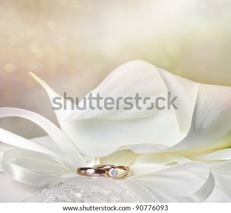 stock photo Wedding background with calla lily and golden rings