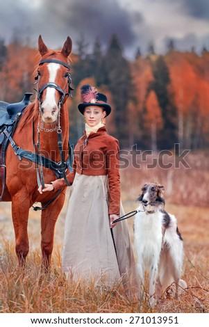 Lady in riding habbit XIX Century with russian borzoy dogs at horse hunting.