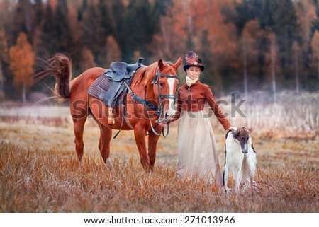 Lady in riding habbit XIX Century with russian borzoy dogs at horse hunting.