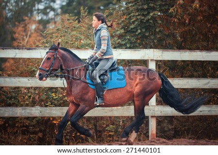 The young woman horseback riding at gallope