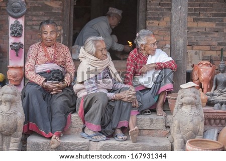 BHAKTAPUR - MAC 25 : Group of unidentified old women besides the street of Bhaktapur, Nepal on Mac 25, 2013. Bhaktapur is best known for its rich cultural heritage, especially its arts and crafts