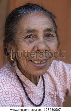PATAN, NEPAL - MARCH 23: Unidentified Nepali old woman poses for camera in Patan, Nepal on March 23, 2013.