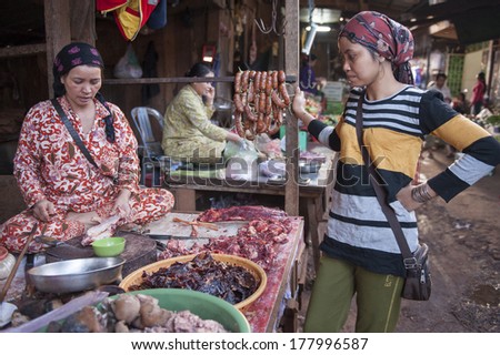 MONDULKIRI, CAMBODIA - JANUARY 4, 2013: Unidentified muslim cham woman at the market in Mondulkiri, Cambodia on January 4, 2013 in Siem Reap, Cambodia.