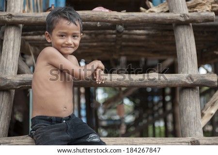 KAMPONG PHLUK,CAMBODIA- DEC 24:Portrait of an unidentified Khmer boy on Tonle Sap Lake in Kampong Phluk,Cambodia on December 24,2011.It is the largest lake in Southeast Asia (up to 16,000 square km).