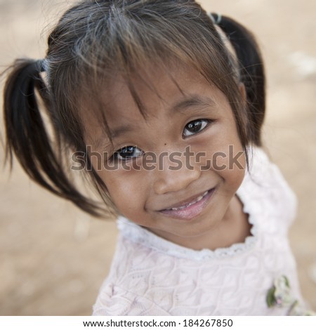 KAMPONG PHLUK,CAMBODIA- DEC 24:Portrait of an unidentified Khmer girl on Tonle Sap Lake in Kampong Phluk,Cambodia on December 24,2011.It is the largest lake in Southeast Asia (up to 16,000 square km).