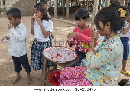 KAMPONG PHLUK, CAMBODIA-DEC 24 : Unidentified girl selling to school childrens during the break on Tonle Sap Lake in Kampong Phluk, Cambodia on December 24,2011.