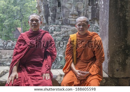 ANGKOR THOM, CAMBODIA - APRIL 18, 2014 - Unidentified Buddhist monks in Bayon temple on April 18, 2014, Cambodia. The Bayon is a well-known and richly decorated Khmer temple at Angkor in Cambodia