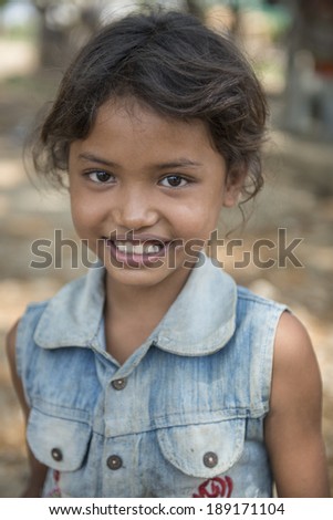 BATTAMBANG, CAMBODIA-APRIL 19: An unidentified Khmer girl smile and poses for a photo on April 19, 2014 in Battambang, Cambodia. Battambang is at the heart of Cambodia\'s \'rice bowl\'.