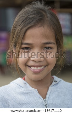 BATTAMBANG, CAMBODIA-APRIL 19: An unidentified Khmer girl smile and poses for a photo on April 19, 2014 in Battambang, Cambodia. Battambang is at the heart of Cambodia\'s \'rice bowl\'.