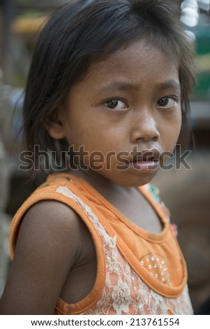 KAMPONG PHLUK,CAMBODIA-APRIL 17:Portrait of an unidentified asian girl on Tonle Sap Lake in Kampong Phluk,Cambodia on April 17, 2014.It is the largest lake in Southeast Asia (up to 16,000 square km).