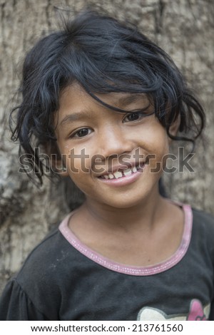KAMPONG PHLUK,CAMBODIA-APRIL 17:Portrait of an unidentified asian girl on Tonle Sap Lake in Kampong Phluk,Cambodia on April 17, 2014.It is the largest lake in Southeast Asia (up to 16,000 square km).