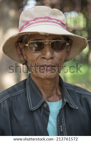 KAMPONG PHLUK,CAMBODIA-APRIL 17:Portrait of an unidentified asian man on Tonle Sap Lake in Kampong Phluk,Cambodia on April 17, 2014.It is the largest lake in Southeast Asia (up to 16,000 square km).