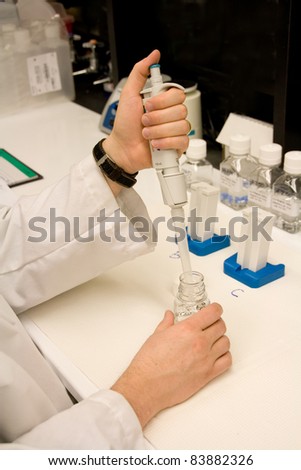 Man in his work area, preparing samples at the lab bench.