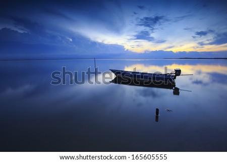 Blue hour sunrise with blue boat hanging