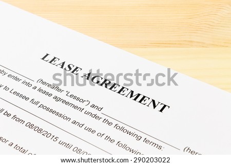 Lease Agreement Contract Document on Wood Table Left Angle View. Legal document for business event