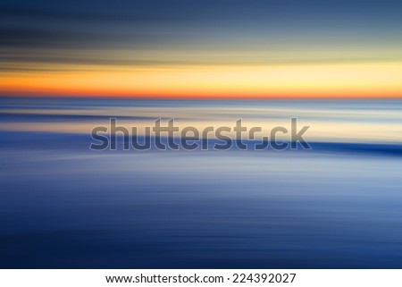 Sunrise at the beach with ICM (intentional camera move) achieved by panning the camera and blurring the image to give abstract seascape