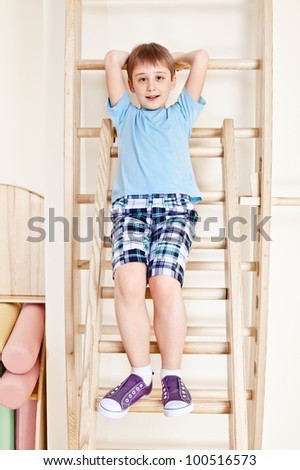 Primary school student sit on wall bars