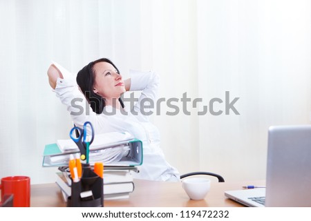 Office lady sits in chair dreaming