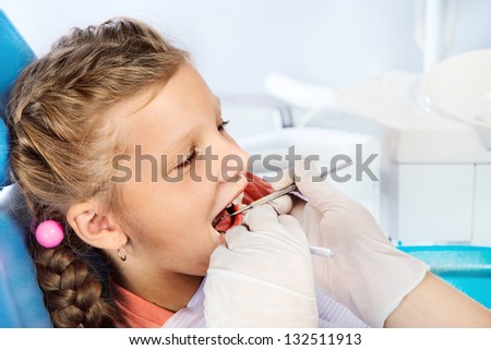 Portrait of a little girl sitting in a dentist\'s chair