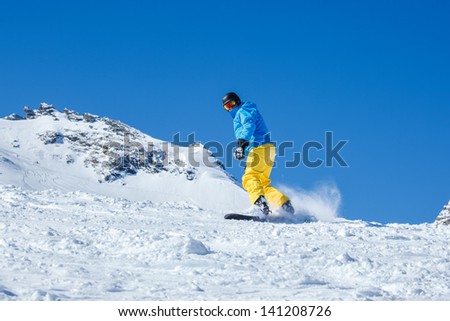 Man snowboarding down the snowy hill
