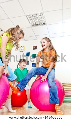 Friends jumping on gymnastic balls