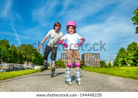 Father and daughter enjoy roller skating