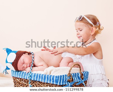 Elder sister taking care of a sleeping infant