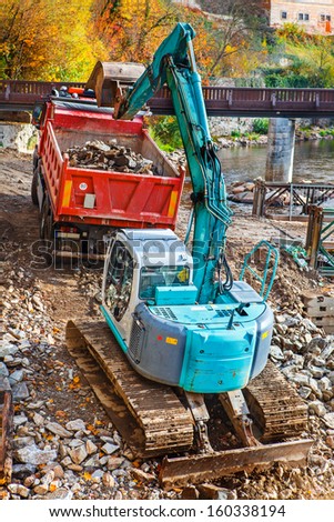 360-degree excavator loading stones to the truck