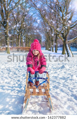 Active girl playing in a winter park
