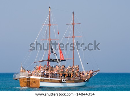 Promenade vessel with tourists on board, stylized as pirate ship