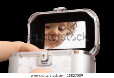 baby girl reflection in the mirror of jewellery or cosmetics box, isolated