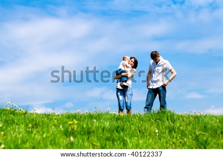 Young family standing on the meadow