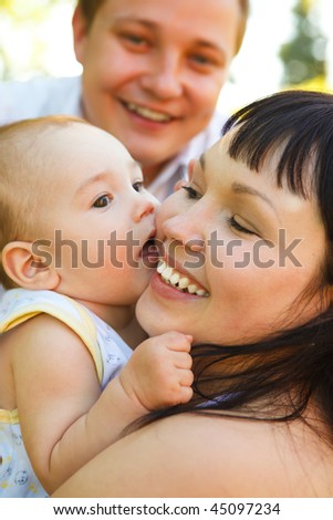 Portrait of the young parents  playing with their baby son