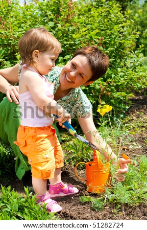 Happy mother and her daughter in the garden
