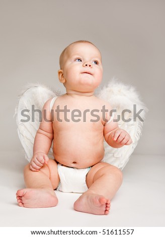 stock photo Baby angel in diaper with white wings over grey