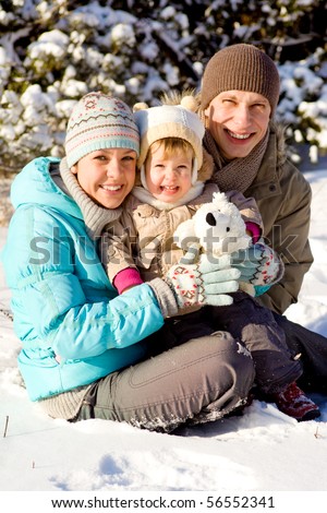 Happy attractive family playing in snow