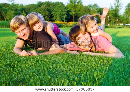 Sweet family playing  on the green grass