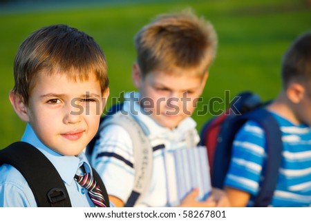 Kids with books sitting in park