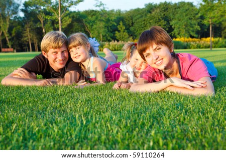 Sweet family lying on grass