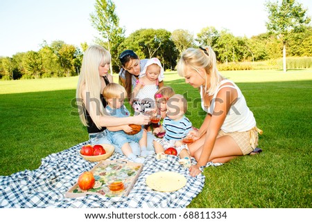 Mothers and kids having picnic in the backyard