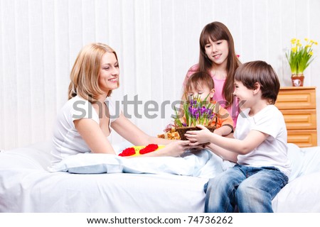 Son presenting flowers to mother