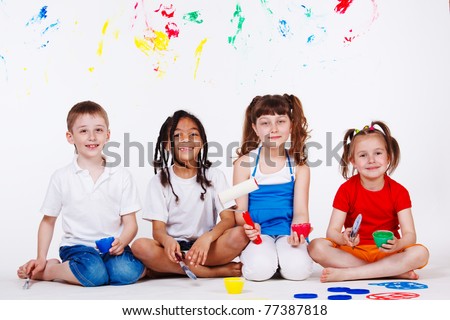 Lovely children with paintbrushes and paint roller