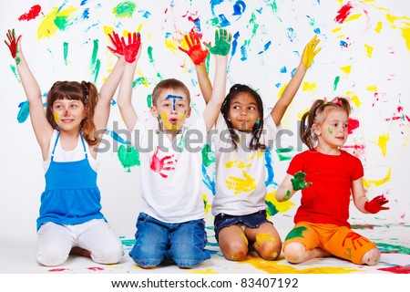 Excited junior students with hands painted