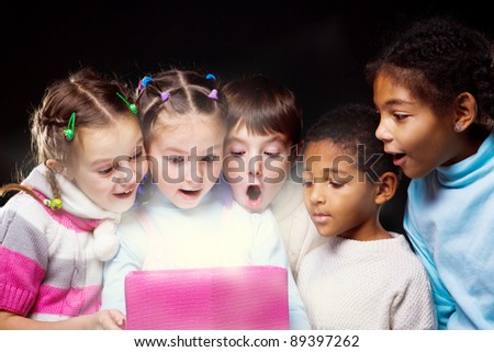Emotional kids looking inside the shining present box