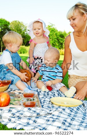 Kids and mothers enjoying picnic in the backyard