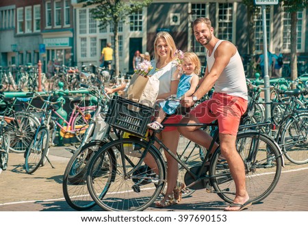 Happy family riding bikes in Amsterdam
