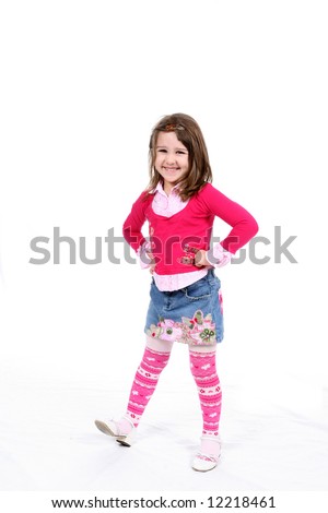 Stylish little girl in pink striped tights and a patterned short denim skirt.