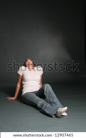 Attractive woman sitting with her head thrown back.
