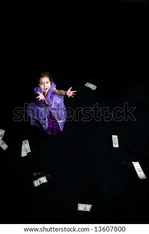 Money falling down and being caught by a pretty little girl.