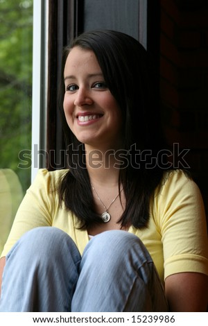 natural light teen at window smiling